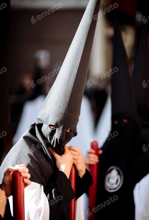 Preview: Mysterious figures in traditional pointy hoods during a procession
