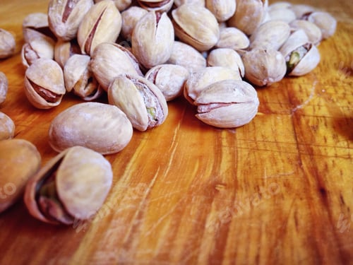 Preview: Pistachios on a wooden chopping board