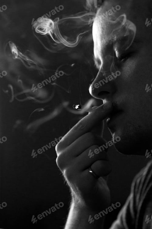 Preview: Black and white man photo of man holding and smoking a joint with smoke in the air