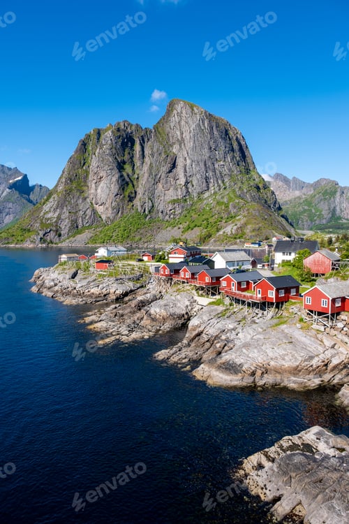 Preview: Hamnoy Lofoten, Vibrant Red Cabins Against Majestic Mountain Backdrop in Norway's Coastal Paradise