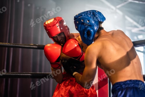 Preview: Two young professional boxer having a competition tournament on stage.