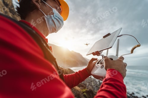 Preview: Male engineer monitoring the drone inspection while wearing face mask to avoid corona virus