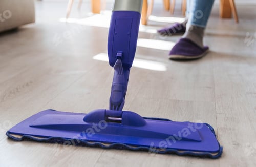 Preview: Close-up cropped image of floor mop, person cleaning floor, spring cleaning.