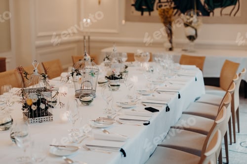 Preview: Elegant decorated table with tableware, prepared for banquet, luxury spacious hall