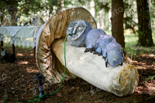 Preview: Caterpillar smoking hookah from Alice wonderland art object outdoor art exhibition in green forest