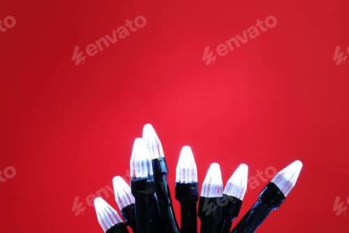 Preview: Beautiful Christmas lights on color background, closeup