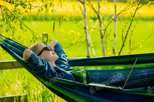 Preview: Woman have a rest in hammock in village in countryside