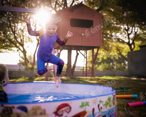 Preview: Boy playing with water in the backyard