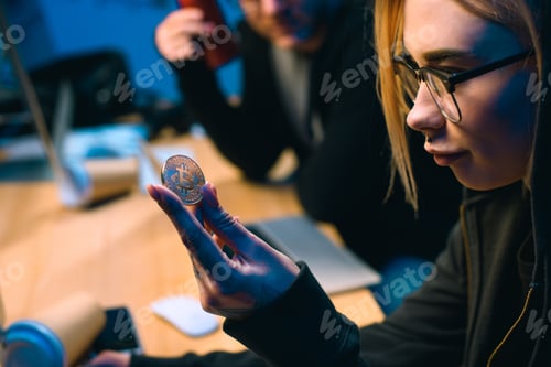 Preview: close-up shot of female hackers holding bitcoin