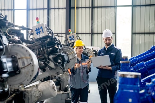 Preview: Engineer with robot in automotive parts factory