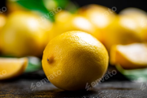 Preview: Fragrant lemons with leaves on the table.