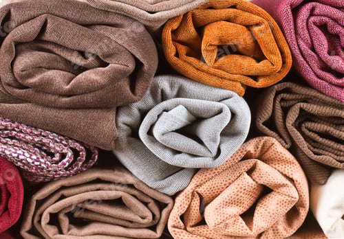 Preview: Pile of folded colorful textile. Roll of cloth fabric