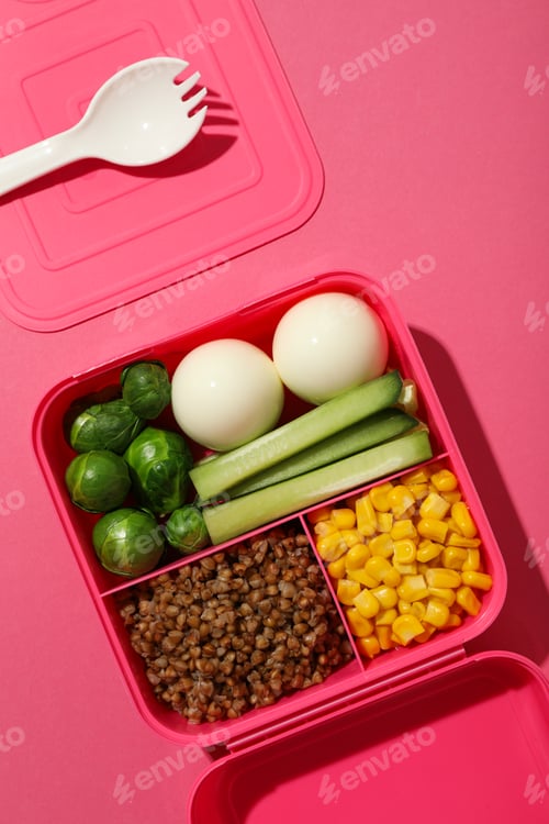 Preview: Pink lunch box with healthy food on a pink background