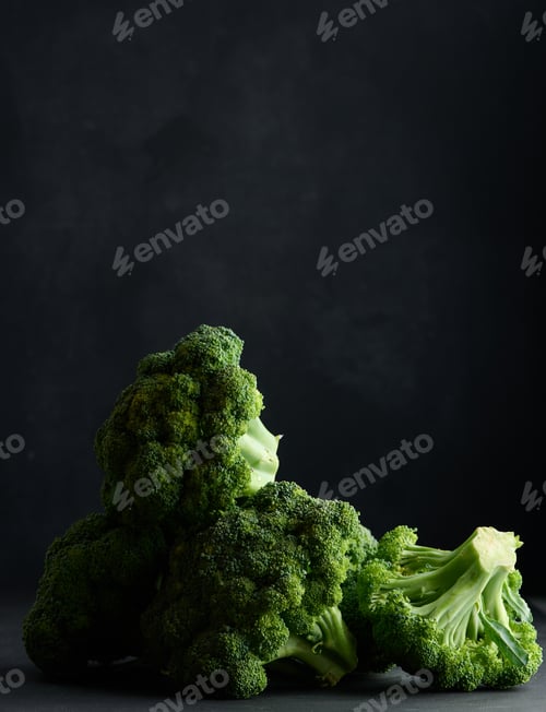 Preview: Fresh green head of broccoli on black background