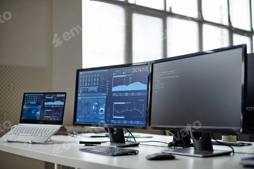 Preview: Computer Screens Showing Data at a Work Station