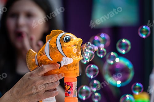 Preview: the toy seller is demonstrating to the buyers a soap bubble gun