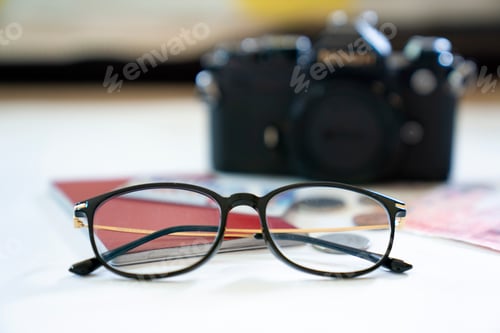 Preview: Travel items isolated on white background. Passport, reading glasses, money and camera