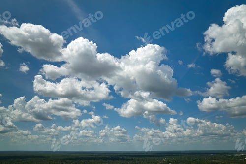 Preview: White puffy cumulus clouds on summer blue sky