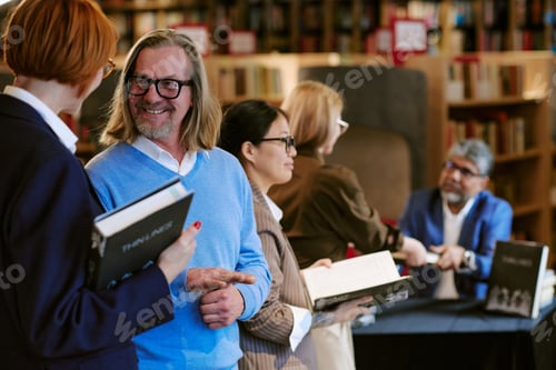 Preview: Middle Aged Caucasian Man Smiling While Waiting in Line at Book Presentation