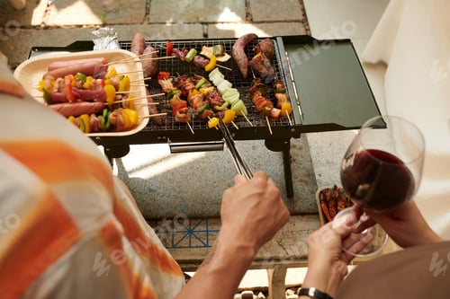 Preview: Couple Cooking Kebabs in Backyard
