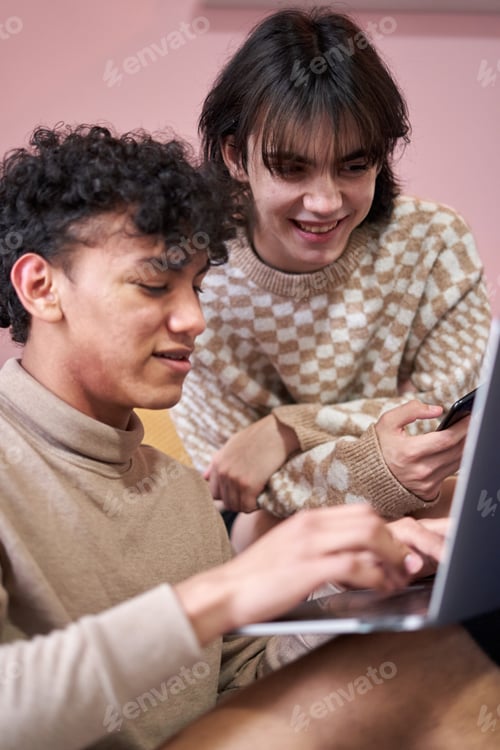 Preview: Happy gay couple using laptop at home