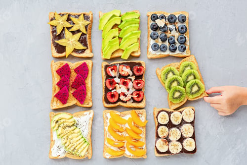 Preview: Colorful flat lay with sandwiches and hand. Healthy eating, fresh fruits