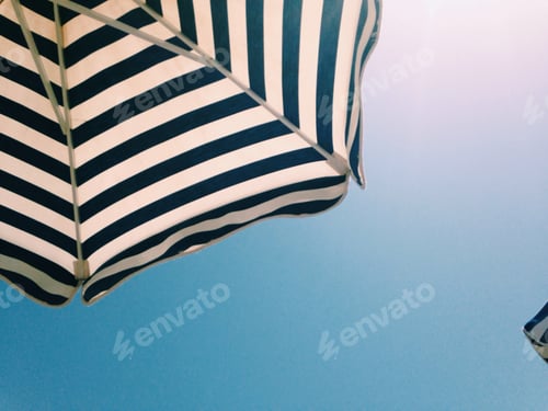 Preview: Striped parasol against the blue sky
