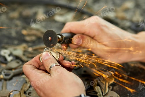 Preview: Locksmith in workshop makes new key, use grinding engraving machine