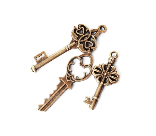 Preview: Bronze vintage ornate keys on white background, top view