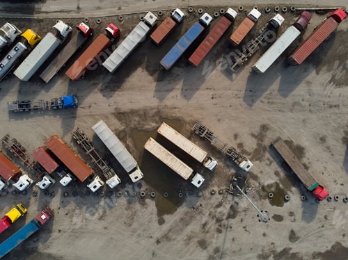 Preview: aerial view of a parking lot of trucks ready for loading containers and delivery