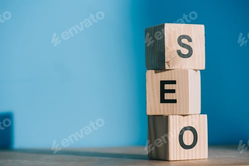 Preview: SEO word made from wooden alphabet cubes on blue background