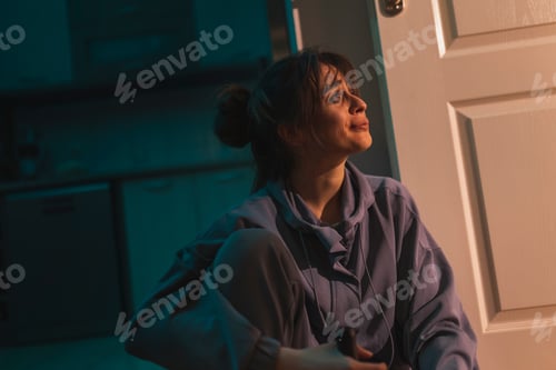 Preview: Depressed woman drinking wine from a bottle
