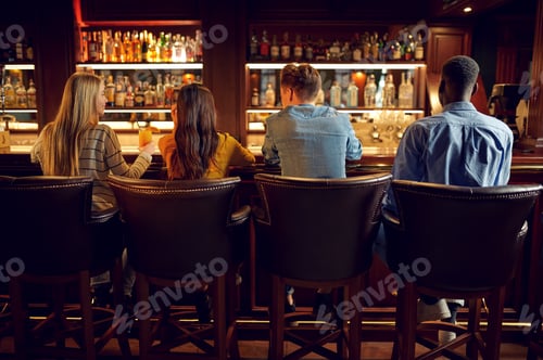 Preview: Four friends at the counter in bar, back view