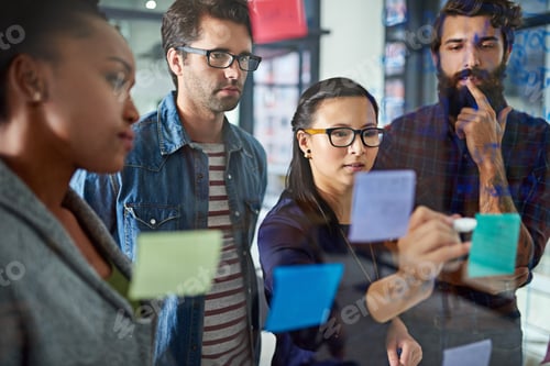Preview: Moving forward together as a team. Cropped shot of coworkers brainstorming in a modern office.