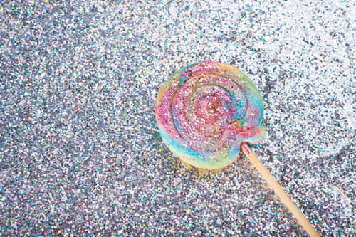 Preview: Rainbow Lollipop On Glitters Isolated on Grey Background