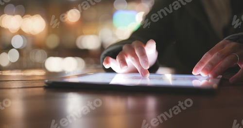 Preview: Using tablet computer at outdoor coffee shop