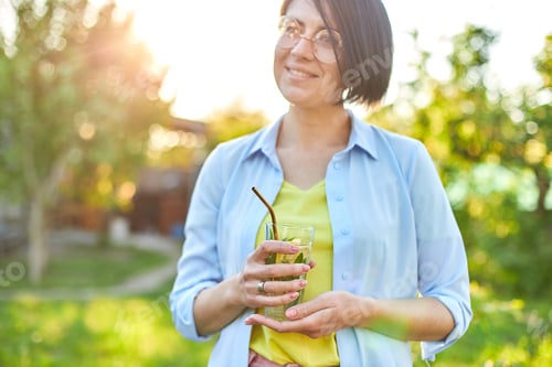 Preview: Woman drinking summer citrus lemonade with reusable metal straws party