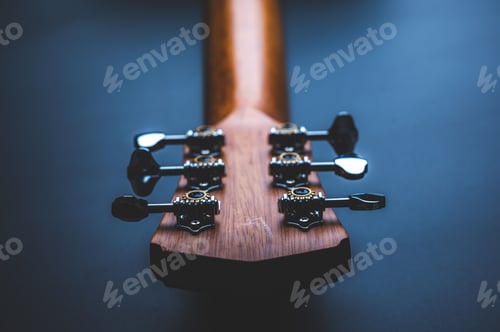 Preview: Acoustic guitar, music instrument resting against a dark black background with copy space