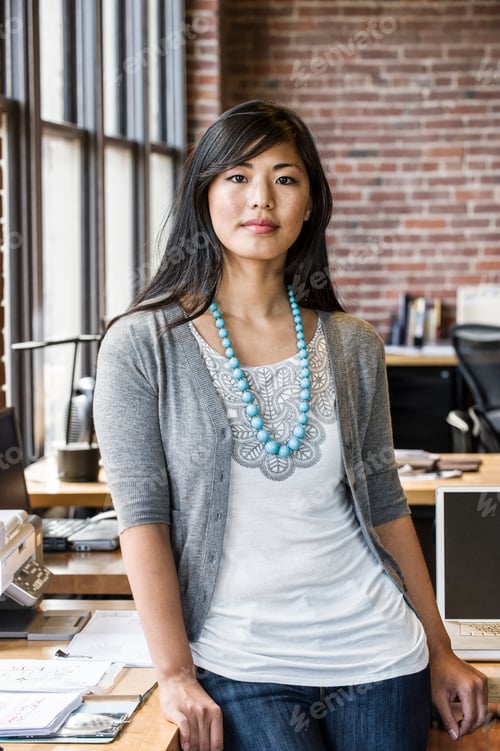 Preview: Asian woman at her creative office work station.