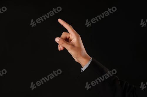 Preview: Man touching something on black background, closeup. Space for text