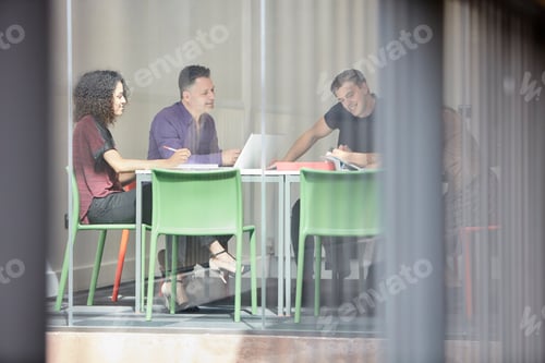 Preview: Design team brainstorming at design studio boardroom table