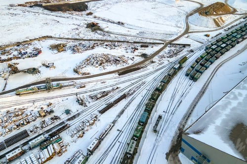 Preview: Aerial view of cargo train loaded with crushed stone materials at mining factory.