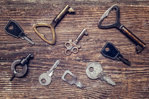 Preview: Old antique key and a set of vintage keys on a wooden background a flat top view, a concept of