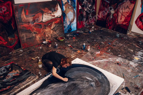 Preview: Female painter artist painting and creating her art in a creative studio