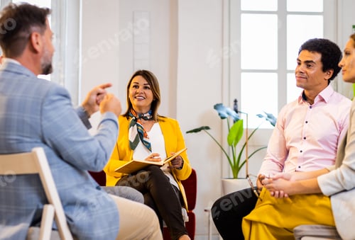 Preview: Group of business people having a meeting while sitting in circle in office.
