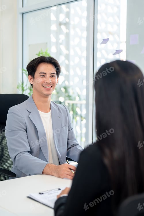 Preview: A confident and friendly Asian businessman or CEO is interviewing a female candidate in his office.