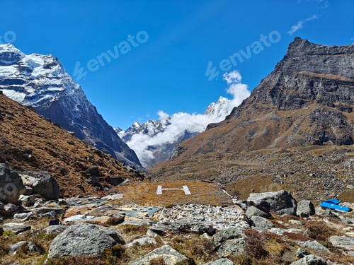Preview: A small airstrip in the Himalayas of Nepal, flanked by towering peaks and blue skies