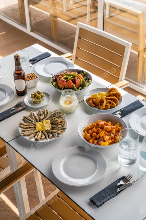 Preview: Mediterranean dishes on a sunlit table.