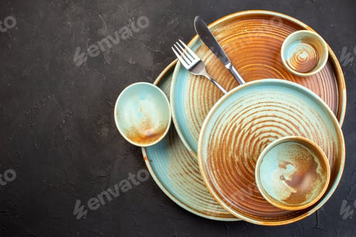 Preview: top view brown plates with fork and knife on dark background table glass ceramic meal color cutlery