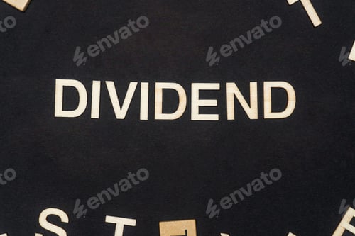 Preview: DIVIDEND word written on dark paper background. DIVIDEND text for your concepts